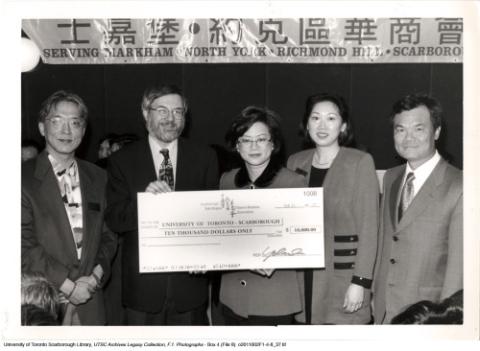 Principal Paul Thompson receiving a cheque for $10,000 from Chinese Business Association