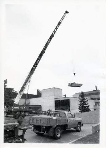 Construction of original Andrews Building showing crane and trucks