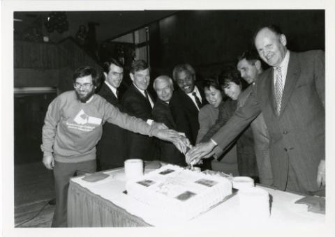 Principal Paul Thompson, MPP Alvin Curling, Councillor Ron Moeser and others cutting UTSC's 25th Anniversary cake