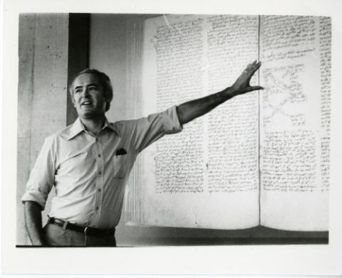 Professor lecturing in front of blackboard
