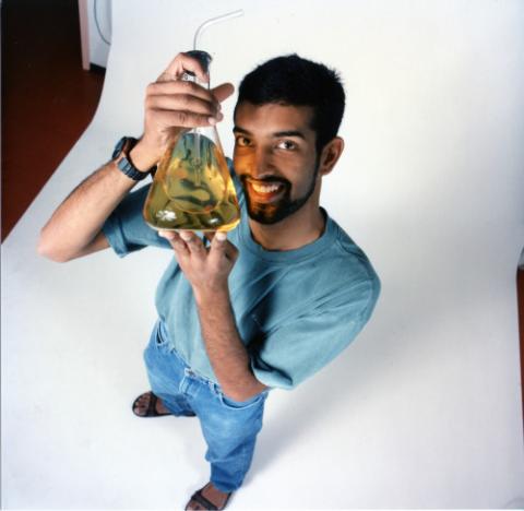 Promotional photograph of man with chemistry beaker; Arvan (?) Governor General Award 1998