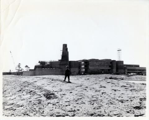 Construction of original Andrews building with child in front