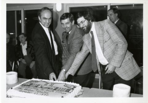 MPP Frankford, Councillor Ron Moeser and Principal Paul Thompson cut the cake at the opening of Phase III Residences