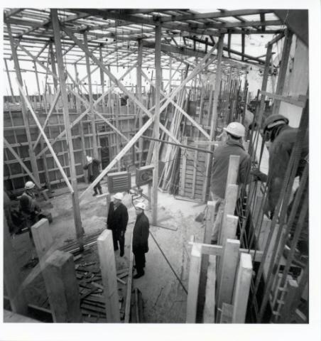 Construction of original Andrews building, view of steel scaffolding and construction worker