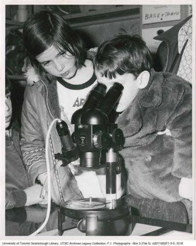 Young Visitor Looking Through Microscope