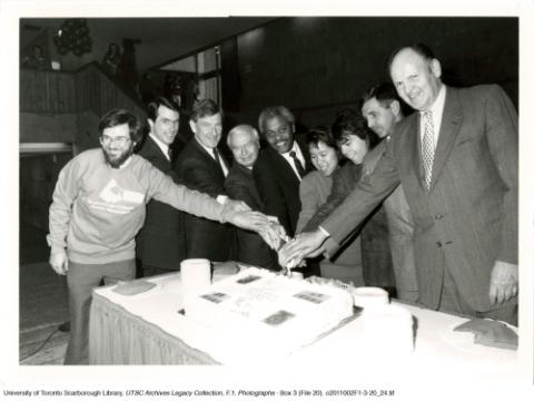 Principal Paul Thompson and Others Cutting 25th Anniversary Cake