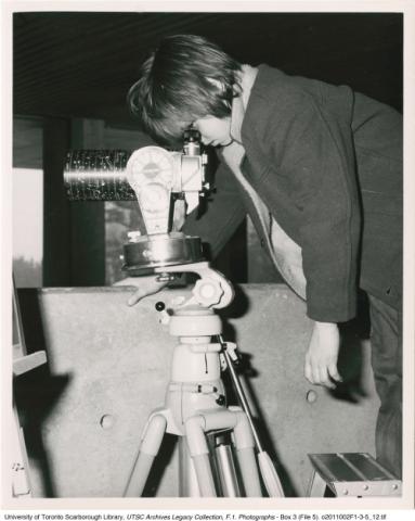 Young visitor looking through Planetarium/Telescope