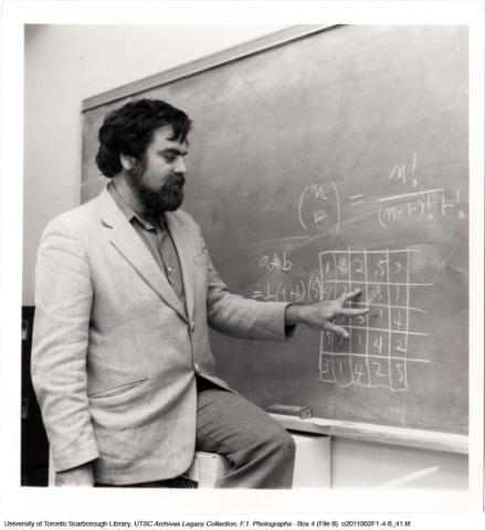 Professor in front of blackboard