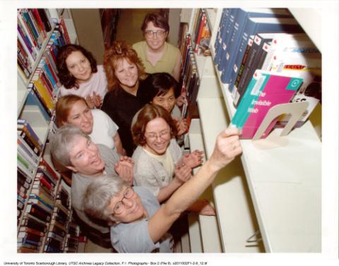 Library staff with last book to be kept in Bladen Library, Scarborough Campus