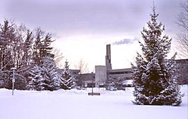 View of H-Wing Chimney Stacks and S-Wing Facade, through Snow Covered Pines