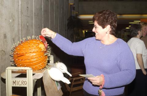 Judge Places 2nd Place Ribbon on 2nd Place Winning Entry, Pumpkin Carving Contest, the Meeting Place