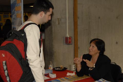 Student Speaks with Presenter at Unidentified Table, Graduate and Professional Schools Fair, 2006, the Meeting Place