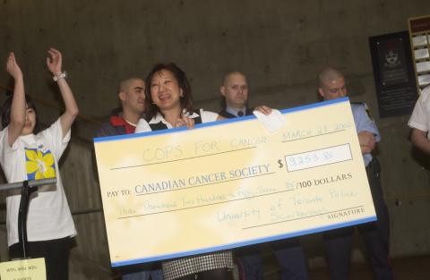 Representatives of Canadian Cancer Society with Campus Police Officers and Novelty Cheque, Cops for Cancer Event, the Meeting Place
