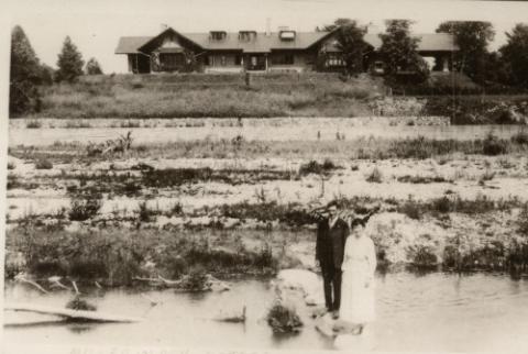 Couple Standing on Lawn in front of Miller Lash House