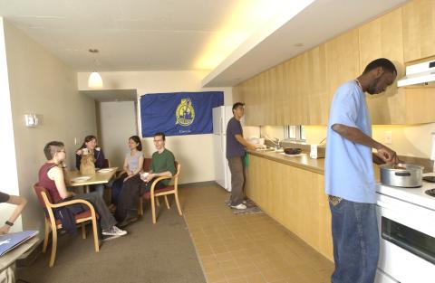Students Grouped around Kitchen Table and working at Kitchen Counter, Residence, Promotional Image