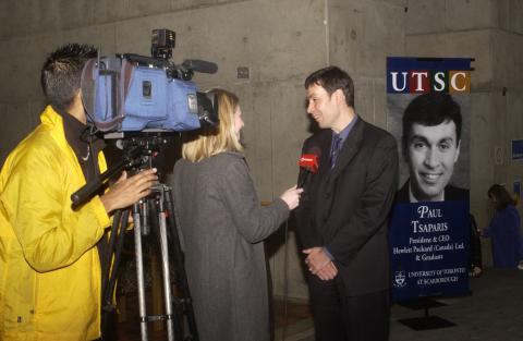 Paul Tsaparis Giving Media Interview in Front of his Banner, Great Minds Campaign Event, the Meeting Place