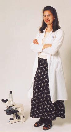Student Wearing White Coat, Standing next to Microscope, Promotional Studio Image