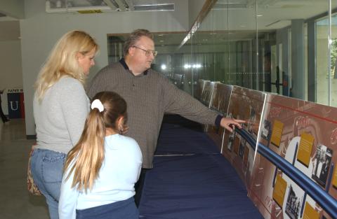 Attendees look at Timeline Display, UTSC Fortieth Anniversary Event