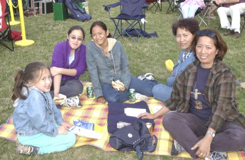 Summerfest, Family Group Sits on Lawn With Blanket