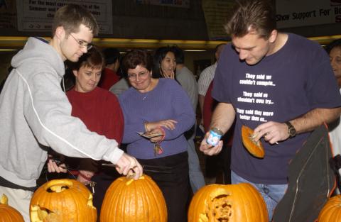 Judges Look at Entry, Pumpkin Carving Contest, the Meeting Place