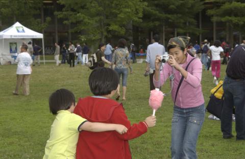 Summerfest, Adult takes Photograph of Children with Cotton Candy