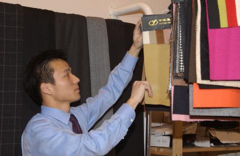 Rocky Zhou, Management and Economics Alumni, with Fabric Samples