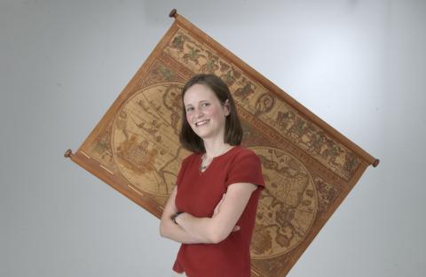 Student Posing in Front of Vintage Map, Promotional Image