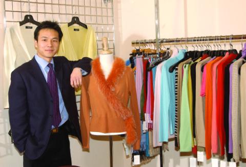 Rocky Zhou, Management and Economics Alumni, With Clothing Racks