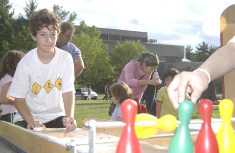 Summerfest, Child Plays Carnival Game with Bowling Pins