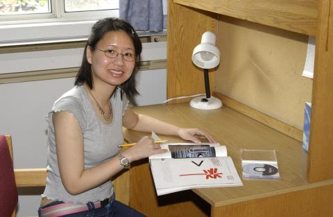 Student at Desk in Residence Room, Joan Foley Residence Hall, Promotional Image
