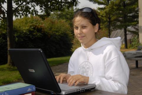 Student with Laptop Working Outdoors, H-Wing Patio
