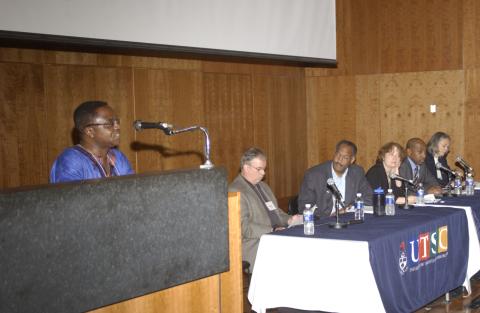 Panelist Speaks at Podium, Other Panelists in Background, Research Symposium in Support of the Mayors Panel on Community Safety, ARC Lecture Theatre, Academic Resource Centre (ARC)