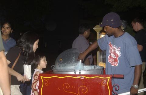 People Getting Cotton Candy from Cart, Outdoor Film Screening