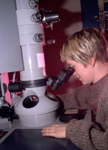 Person using Microscope