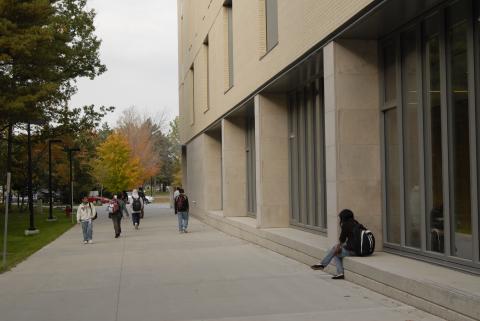 Students Walk Along Path between Wooded Area and Arts & Administration Building (AA)