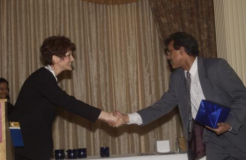 Unidentified Woman Shakes Hands with Award Winner, Management and Economics Student Association Banquet, Crystal Fountain Banquet Hall, Markham, ON