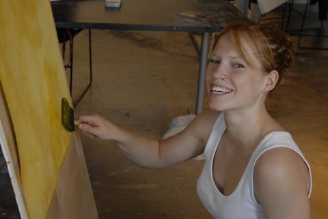 Student, Painting at Easel in Studio, Smiles for Camera