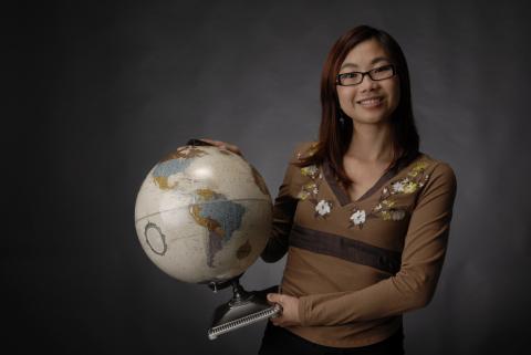 Student with Desktop Globe, Promotional Image