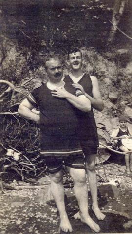 Two Men in Swimsuits, early 1900s.  Child in background.