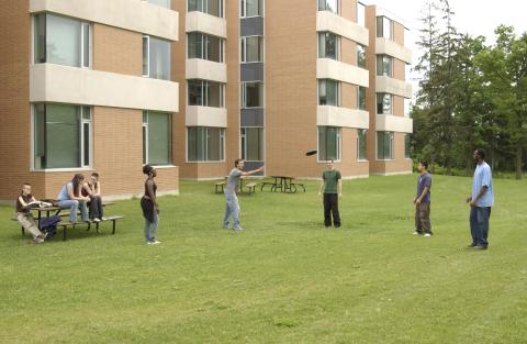 Students Play Frisbee Outside Joan Foley Residence Hall, Promotional Image