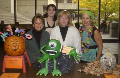 People Pose for Photograph with Registrarial Services Pumpkin Carving Contest Entry. the Meeting Place