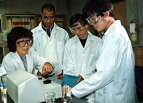 Four Students working in Chemistry Lab