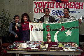 Representatives of Pakistani Students Association Hold Flag at Table. Event in the Meeting Place