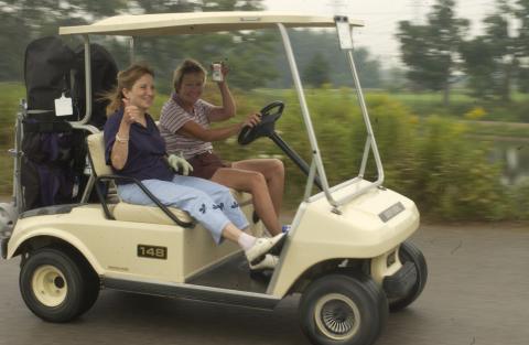 Players in Cart, Wave and Raise Drink to Camera, Management Alumni Association Golf Tournament, 2002, Deer Creek Golf Club