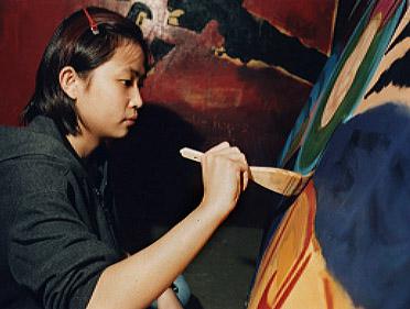 Student Painting in Art Studio