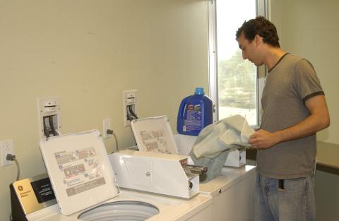 Student Does Laundry, Joan Foley Residence Hall, Promotional Image