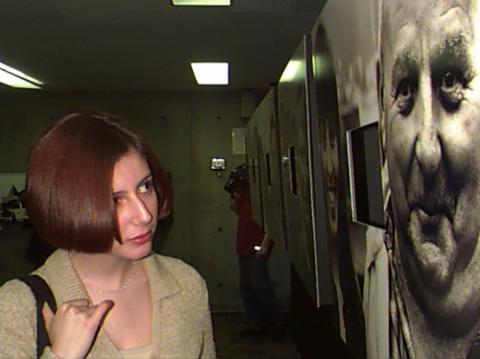 Woman Looks at Artwork in Gallery