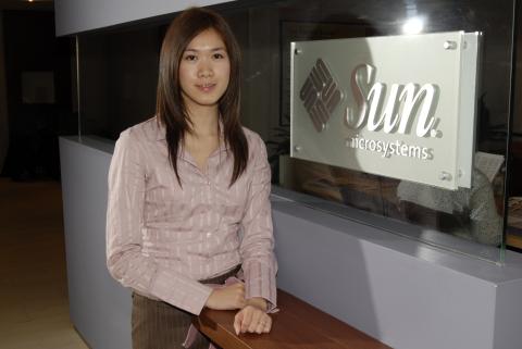Co-op Student Stands beside Corporate Signage, Management and Economics Co-op Placement, Sun Microsystems, Inc., Promotional Image