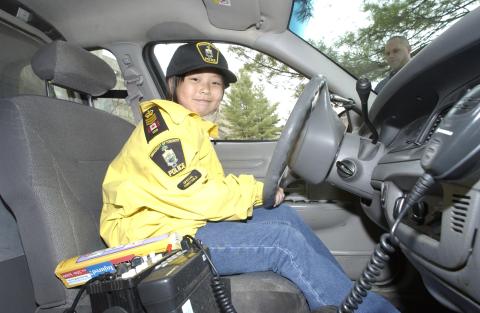 Child Sitting in Driver's Seat, Campus Police Car, Bring our Children to Work Day