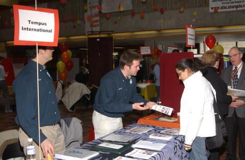 Student Speaks with Presenter at Tempus International Table, Volunteer Fair, the Meeting Place